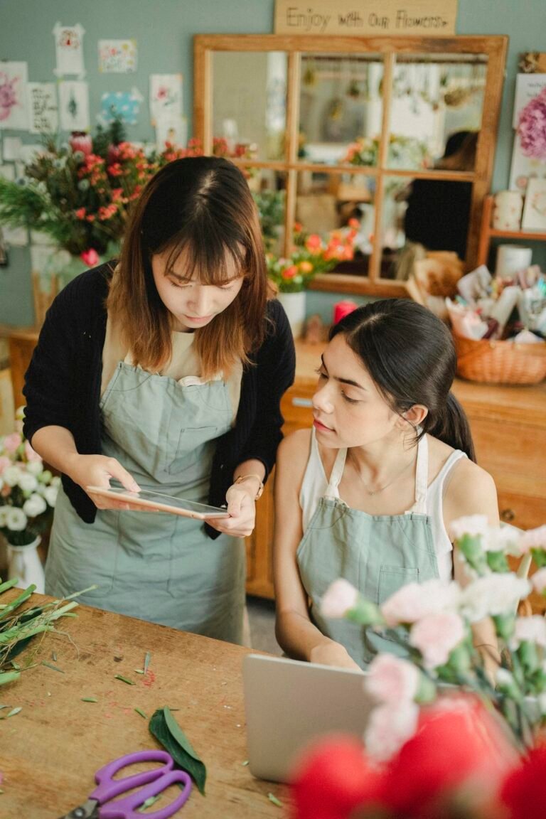 Focused multiracial florists browsing tablet in shop