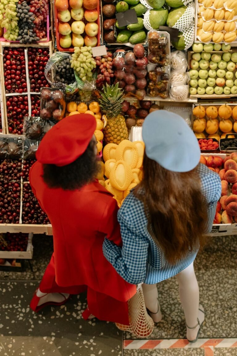 Women Standing in Front of a Fruits Stand